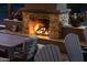 Cozy outdoor stone fireplace, perfect for gathering and relaxation, near an outdoor dining area at 18919 W Verde Ln, Litchfield Park, AZ 85340