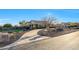 Captivating single-story home with a stone accented porch, desert landscaping, and a paved driveway at 18919 W Verde Ln, Litchfield Park, AZ 85340