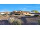 Charming single-story home with a stone accented porch, desert landscaping, and a spacious front yard at 18919 W Verde Ln, Litchfield Park, AZ 85340
