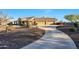Beautiful single-story home with a three-car garage, desert landscaping, and covered front porch at 18919 W Verde Ln, Litchfield Park, AZ 85340