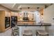 Kitchen boasting granite countertops, wooden cabinets, and bar stool seating at 18919 W Verde Ln, Litchfield Park, AZ 85340