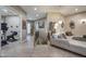 Bright living room with a sectional sofa, staircase, and an open doorway to the exercise room at 18919 W Verde Ln, Litchfield Park, AZ 85340