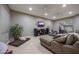 Bright living room with a large sectional sofa, ceiling fans, and a TV at 18919 W Verde Ln, Litchfield Park, AZ 85340