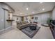Spacious basement living room with a sectional sofa and plenty of space for entertaining at 18919 W Verde Ln, Litchfield Park, AZ 85340