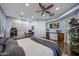 Large main bedroom features wood floors, a ceiling fan, and a desk area at 18919 W Verde Ln, Litchfield Park, AZ 85340