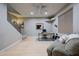 Basement office space featuring a desk, staircase, and a comfortable sofa at 18919 W Verde Ln, Litchfield Park, AZ 85340