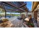 Beautiful outdoor kitchen with an island, a built-in grill, fireplace, and a view of the sparkling pool at 18919 W Verde Ln, Litchfield Park, AZ 85340