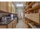 Well-organized pantry with ample shelving and counter space for storage and food preparation at 18919 W Verde Ln, Litchfield Park, AZ 85340