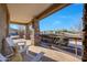 Relaxing front porch showcasing beautiful stone pillars and comfortable white Adirondack chairs at 18919 W Verde Ln, Litchfield Park, AZ 85340