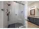 Stylish bathroom featuring a glass enclosed tiled shower with built-in bench and a view into the bathroom at 18919 W Verde Ln, Litchfield Park, AZ 85340