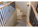 Carpeted staircase with decorative wrought iron railing leading to a lower level at 18919 W Verde Ln, Litchfield Park, AZ 85340