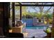 View from the patio to the swimming pool with waterfall feature and a beautiful tropical landscape at 18919 W Verde Ln, Litchfield Park, AZ 85340