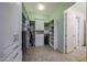Walk-in closet featuring custom storage solutions: shelves, drawers, and hanging rods for clothes, shoes, and accessories at 18919 W Verde Ln, Litchfield Park, AZ 85340