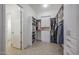 Well-organized walk-in closet with custom shelves, drawers, and hanging rods for maximum storage and functionality at 18919 W Verde Ln, Litchfield Park, AZ 85340