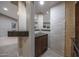 Basement wet bar featuring granite countertops and wooden cabinetry at 18919 W Verde Ln, Litchfield Park, AZ 85340