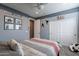 Bedroom featuring a ceiling fan, a neutral color scheme, and a sliding-door closet for extra storage at 1970 E Lafayette Ave, Gilbert, AZ 85298