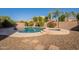 Beautiful backyard featuring a pebble tec pool and spa, surrounded by lush desert landscaping at 1970 E Lafayette Ave, Gilbert, AZ 85298