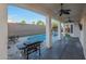 Relaxing covered patio featuring a grill, ceiling fan, and view of the pool and backyard at 20709 N 56Th Dr, Glendale, AZ 85308