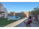 The backyard features a clean pool, concrete patio, artificial grass, and privacy walls at 20709 N 56Th Dr, Glendale, AZ 85308