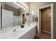 Well-lit bathroom with double sinks, a large mirror, and a combined shower and tub at 20709 N 56Th Dr, Glendale, AZ 85308