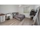 Bright bedroom featuring a modern desk, large window, and cozy queen-sized bed at 20709 N 56Th Dr, Glendale, AZ 85308