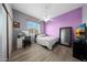 Cozy bedroom featuring laminate floors, a ceiling fan, and comfortable decor at 20709 N 56Th Dr, Glendale, AZ 85308