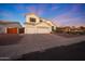 Charming two-story home with a three car garage, neutral colored stucco, and desert landscaping at 20709 N 56Th Dr, Glendale, AZ 85308