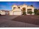 Elegant two-story home with a three car garage, desert landscaping, and a covered front porch at 20709 N 56Th Dr, Glendale, AZ 85308