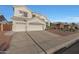 Two-story stucco home features a three-car garage, desert landscaping, and tile roof at 20709 N 56Th Dr, Glendale, AZ 85308