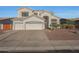 Gorgeous stucco home with large arched window, three-car garage, and low maintenance desert landscaping at 20709 N 56Th Dr, Glendale, AZ 85308