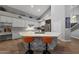 Bright kitchen boasts white cabinets, marble counters, and a stylish island with seating at 20709 N 56Th Dr, Glendale, AZ 85308