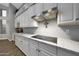 Well-appointed kitchen with marble countertops, a cooktop, and white cabinetry at 20709 N 56Th Dr, Glendale, AZ 85308