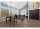 Open-concept living room features vaulted ceilings, dark wood floors, and a lovely chandelier at 20709 N 56Th Dr, Glendale, AZ 85308