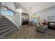 Open-concept living space with soaring ceilings, wood-look tile flooring, and a grand staircase at 20709 N 56Th Dr, Glendale, AZ 85308
