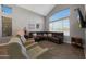 Inviting living room features a soaring vaulted ceiling, large window, and cozy furniture at 20709 N 56Th Dr, Glendale, AZ 85308