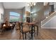 Bright living room with soaring ceilings, dark wood floors, and elegant staircase at 20709 N 56Th Dr, Glendale, AZ 85308