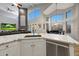 Open-concept kitchen overlooks a well-lit living area featuring a fireplace and large windows at 20709 N 56Th Dr, Glendale, AZ 85308