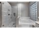Close-up of the main bathroom's shower and tub featuring marble tile at 20709 N 56Th Dr, Glendale, AZ 85308
