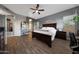 Comfortable main bedroom with wood floors, a ceiling fan, and stylish decor at 20709 N 56Th Dr, Glendale, AZ 85308