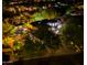 Night aerial view showing a well-lit property with a pool, mature trees, and landscape lighting at 22339 N 77Th Way, Scottsdale, AZ 85255