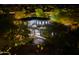 Night aerial view showcasing a property surrounded by mature trees and landscape lighting at 22339 N 77Th Way, Scottsdale, AZ 85255