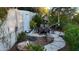 Landscaped backyard featuring a dining area, stone pathway, and lush greenery at 22339 N 77Th Way, Scottsdale, AZ 85255