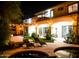 Beautiful backyard view at night featuring a pool, outdoor kitchen, patio, and charming string lights at 22339 N 77Th Way, Scottsdale, AZ 85255