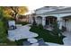 Expansive backyard featuring a built-in grill, lush artificial turf, and travertine-style patio at 22339 N 77Th Way, Scottsdale, AZ 85255