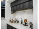 This bar features a marble countertop and a hanging wine glass rack below the cabinets at 22339 N 77Th Way, Scottsdale, AZ 85255