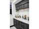 Bar with wine glass racks, marble countertop, and a collection of liquor bottles at 22339 N 77Th Way, Scottsdale, AZ 85255