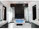 A spa-like bathroom with a modern tub, dual showers, and sleek black and white design at 22339 N 77Th Way, Scottsdale, AZ 85255