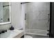 Modern bathroom showcasing elegant marble tiles, toilet, shower and vanity with illuminated mirror at 22339 N 77Th Way, Scottsdale, AZ 85255