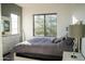 Bright bedroom featuring a large window, gray duvet cover, and white dresser with mirror at 22339 N 77Th Way, Scottsdale, AZ 85255