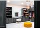 Custom walk-in closet with ample storage, vanity area, plush seating, and a stylish chandelier at 22339 N 77Th Way, Scottsdale, AZ 85255
